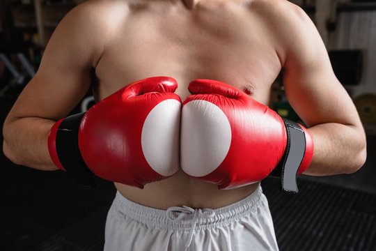 Mid-section of boxer in boxing gloves