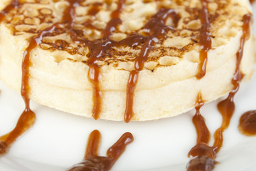 Close up of a fresh crumpet covered with chocolate sauce