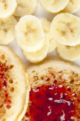 Close up of crumpets covered with strawberry jam with banana