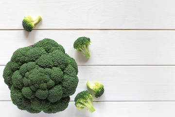 Fresh broccoli on a wooden table, top view. - 124273955