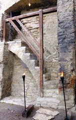 Medieval castle stairs. Torches at the entrance.