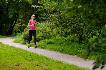 Young slim woman jogging in a park