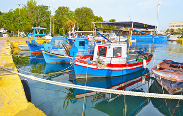 boats reflected on sea at Eleusis port Greece