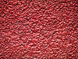 Red plastered wall background texture.