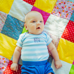 Baby on the coverlet