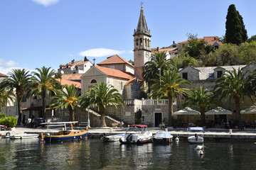 Fototapeta premium Harbor in the little village Splitska on Brac Island in Croatia, with some small boats and the old church.