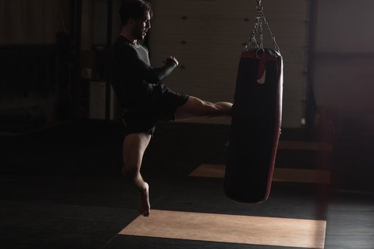 Boxer practicing boxing with punching bag
