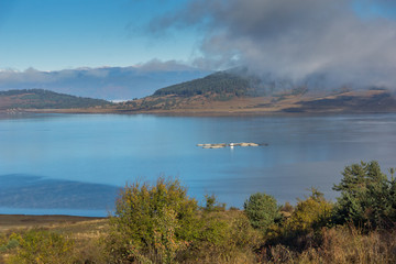 Amazing Autumn Landscape with Low clouds over water of Batak Reservoir, Pazardzhik Region, Bulgaria