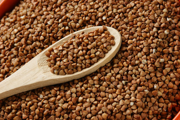 buckwheat groats and wooden spoon