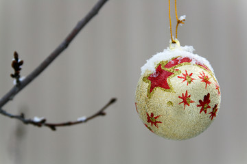 Golden ball hanging on a branch. Christmas New Year's toy.
