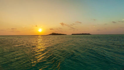 Romantic orange sunset with tropical island, Maldives