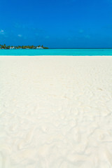 Seascape with rolling waves on a sandy beach and boats, Maldives