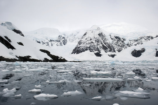 Mountains and glaciers reflected in the water;Antarctica