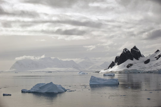 Icebergs and mountains along the coastline;Antarctica