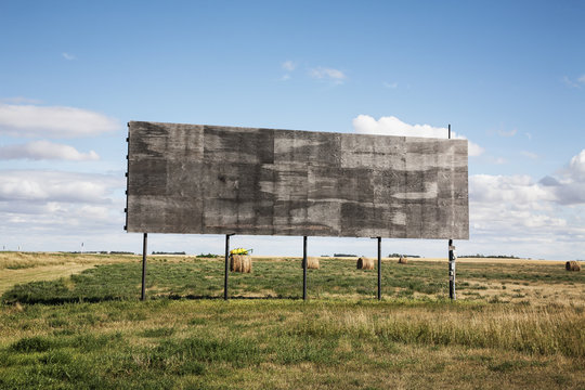 An Empty Billboard Beside A Farm Field; Alberta, Canada