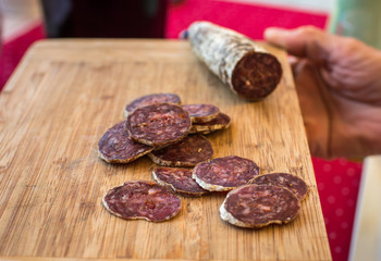 sliced sausage on a wooden board