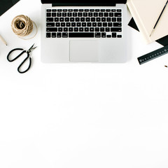 Flat lay, top view office table desk. Workspace with laptop, scissors, pencils, succulent and diary on white background.