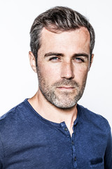 Obraz premium portrait, arrogant handsome bearded young man with staring blue eyes