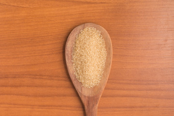 Demerara Sugar into a spoon