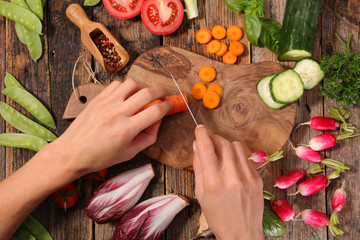 woman cutting raw vegetable