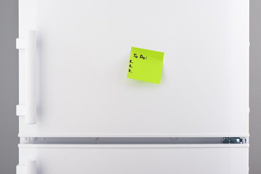 To do list on green note paper on white refrigerator