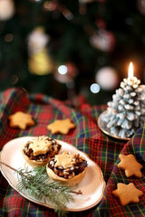Christmas pastry filled with apples, almonds and chocolate with star shaped cookies. Selective focus and festive background. 