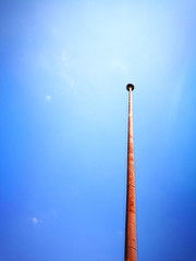 Old rusty column against blue sky