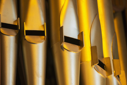 Close up of the gold pipes of a pipe organ; Northumberland, England