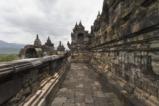 Bas-reliefs depicting the life of Buddha on a gallery of Candi Borubudur, Borobudur Temple Compounds, Central Java, Indonesia