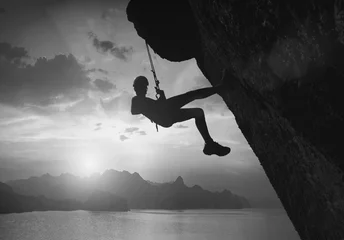 Foto op Aluminium Climber against sunset. Black and white © Bashkatov