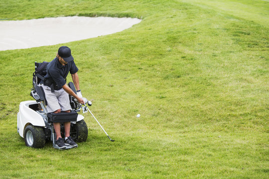 Disabled golfer in a tournament using high tech mobility aid; Edmonton, Alberta, Canada