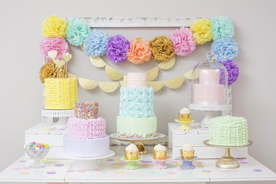 Rows of cupcakes and cakes on dessert table; Toronto, Ontario, Canada