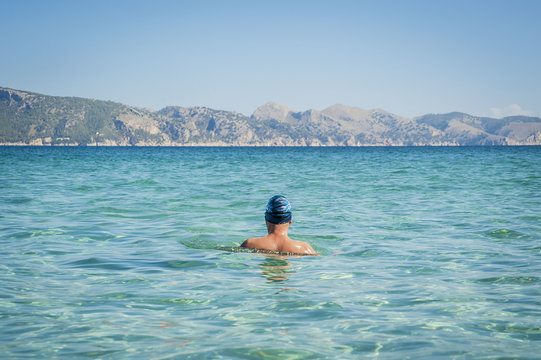 Back of a male swimmer; Cala Sant Joan, Alcudia, Mallorca, Spain
