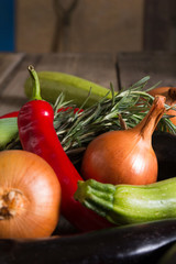 Different kind of local vegitables on the wooden rustic table. Organic food concept
