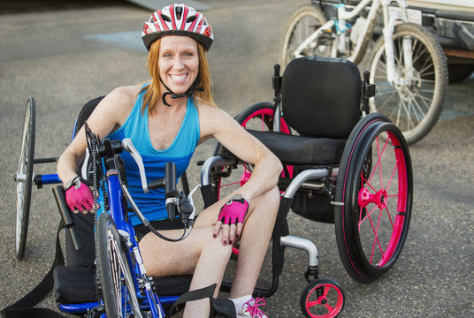 Woman with spinal cord injury cycling using hand propelled bicycle; Edmonton, Alberta, Canada
