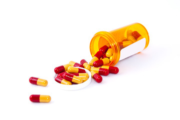 Pills spilling out of pill bottle.