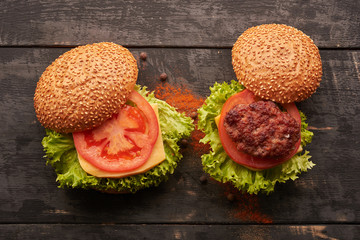 Two hamburger on a wooden table