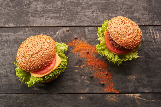 Two hamburger on a wooden table