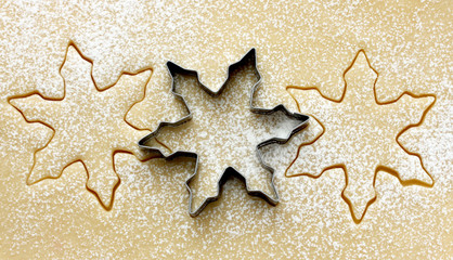 Snowflake cutter for Christmas cookies on raw dough