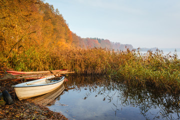 Two fishing boats on the lake in the morning. Autumn landscape.