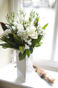 Bouquet of White Flowers on Sunny Window Sill