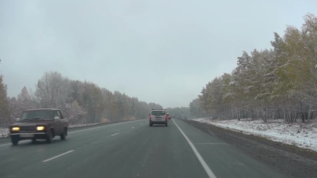 Early snow in October in Siberia, commuter highway
