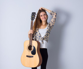 Young woman holding a guitar 