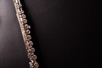 Detail of tansverse flute on black table top view © Davizro Photography