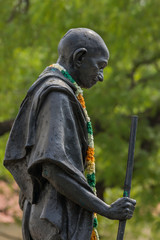 Madurai, India - October 21, 2013: Black life-size statue of Mahatma Gandhi in front of his museum....