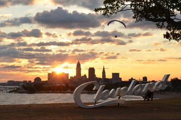 Morning view of Cleveland skyline, Lake Erie, and paraglider from Edgewater park