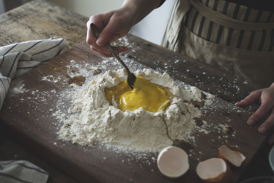 Woman mixing eggs and flour 