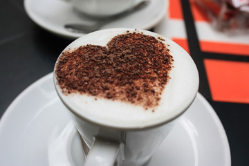 A cup of espressino decorated with heart