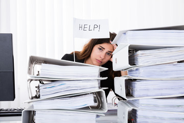 Unhappy Businesswoman Holding Help Flag In Office