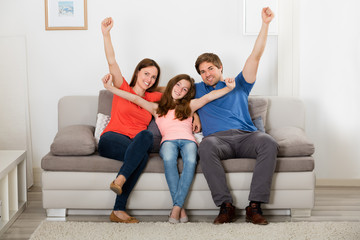 Family Raising Their Arms